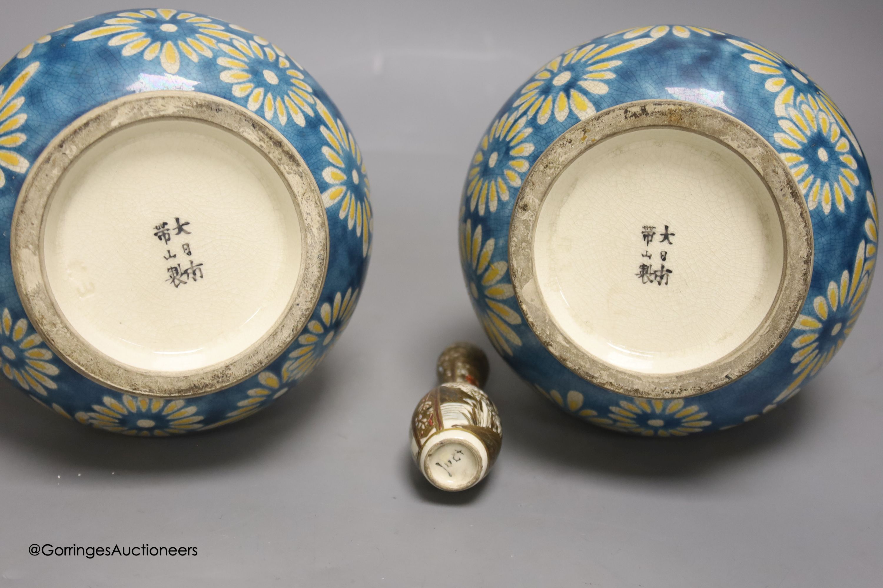 A pair of Japanese Satsuma pottery bottle vases by Taizan Yohei IX, 30cm and a miniature Satsuma vase